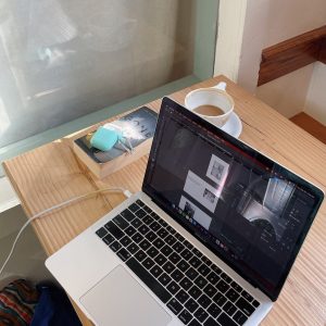 Creative blogger’s desk with laptop - phone, -and morning coffee symbolizing blogging for profit success.